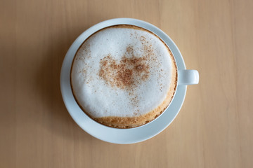 cup of coffee on wooden table.