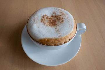cup of coffee on wooden table.