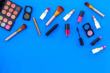 decorative cosmetics on woman desk blue background top view mockup