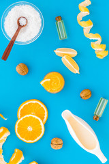 organic cosmetics for homemade spa with orange oil blue background top view pattern