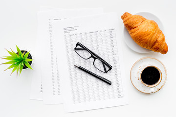Business lunch with croissant and black coffee on work desk white background top view