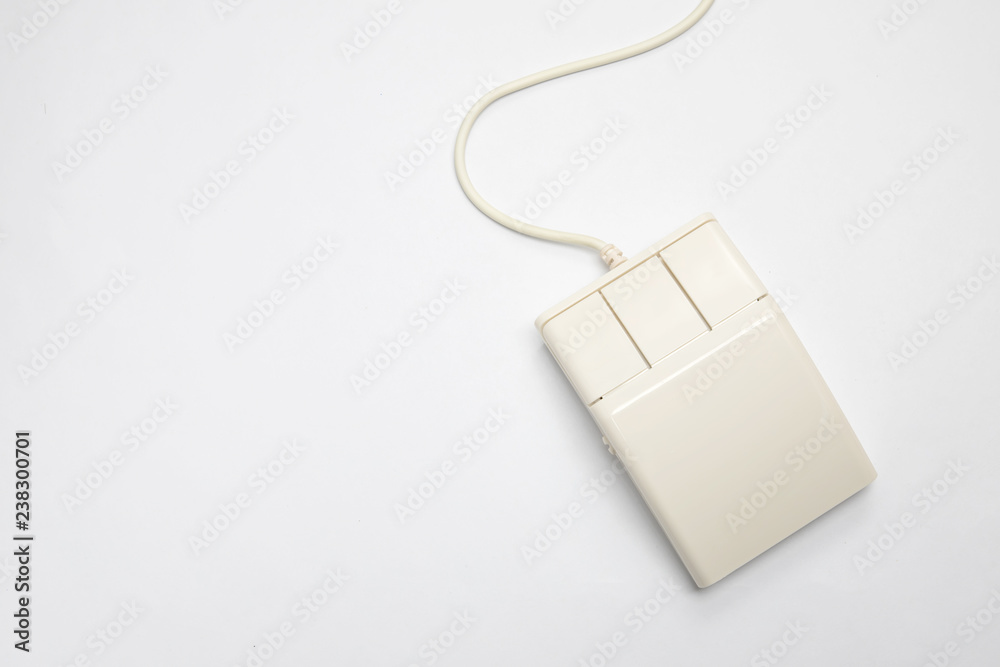 Wall mural retro white three-button computer mouse on a white background with copy space. top view of an old-fa