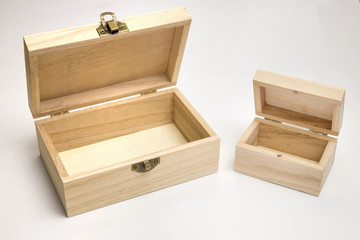 Two empty wooden caskets with open lids. Big and small box of eco-friendly materials on a white...