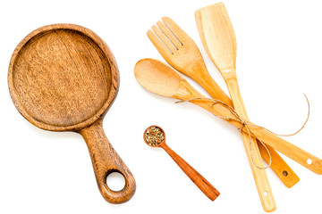 Fork, spoon, pan in woodenware set on white background top view