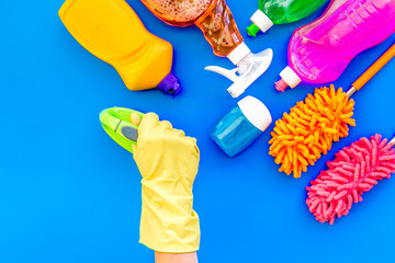 Housecleaning with detergents, soap, cleaners and brush in plastic bottles on blue background top view mockup