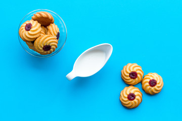 Children tradition evening dessert. Milk and homemade cookies on blue background top view