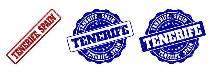 TENERIFE, SPAIN scratched stamp seals in red and blue colors. Vector TENERIFE, SPAIN marks with grunge effect. Graphic elements are rounded rectangles, rosettes, circles and text captions.