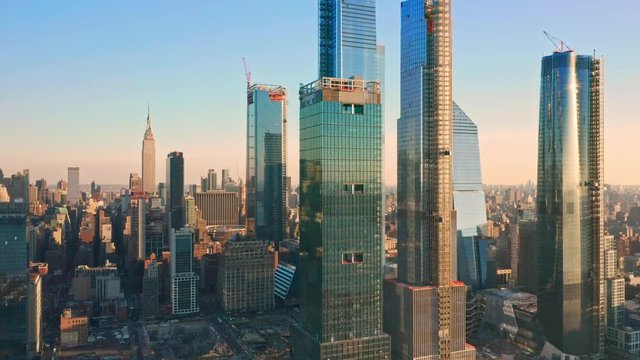 Aerial drone footage of New York skyline panning along Hudson Yards midtown Manhattan skyscrapers (some still being under construction)