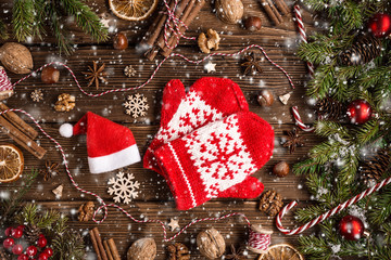 Christmas wooden background with fir tree and mittens
