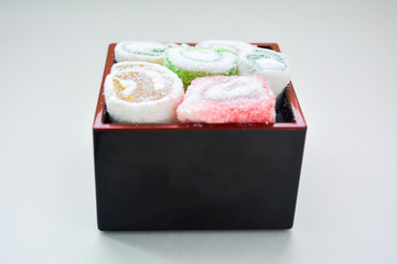 Delicious rolls of Lokum with fruit marmalade in japanese style in black box