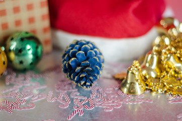 Christmas decoration with Santa Claus hat, golden little bells and christmas balls. Christmas composition