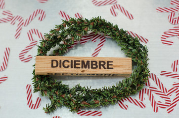 Christmas crown with december calendar and candy canes confetti against metal background. Christmas decoration