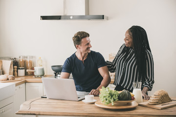 Happy married interracial couple at home in the morning