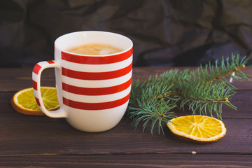 Cup of coffee and christmas fir branch