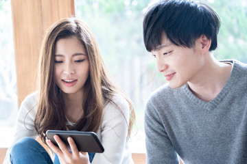 young asian couple relaxing in living room
