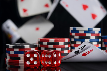 Obraz premium set for playing for money, two aces and dice on a black background, flying cards