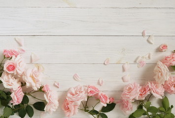 Flowers background. Bouquet of beautiful pink roses on white wooden background.Top view.Copy space