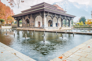 Oblique view of Mughal Heritage Building with reflection in the pool during Autumn in Shalimar Bagh Mughal Garden of Kashmir