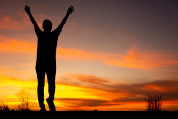 Young woman relaxing in winter sunset sky outdoor.