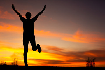 Young woman relaxing in winter sunset sky outdoor.