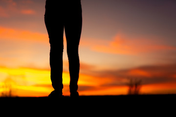 Silhouette of sad and depressed women walking at walkway of park with sunset