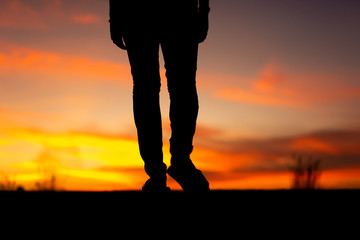 Silhouette of sad and depressed women walking at walkway of park with sunset