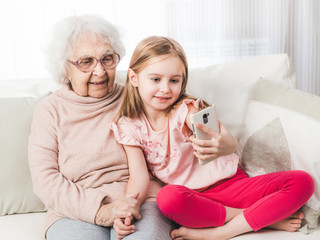 Granddaughter taking selfie with great-grandmother