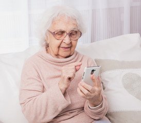 Great-grandmother talking by smartphone