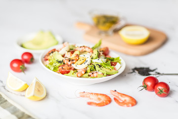 Fresh salad lying in white plate