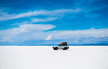 Sunshine scenery of Salar de Uyuni in Bolivia and car