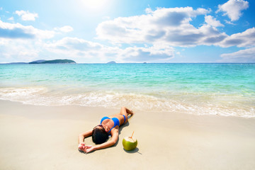 Fototapeta na wymiar Beautiful girl with coconut on beach