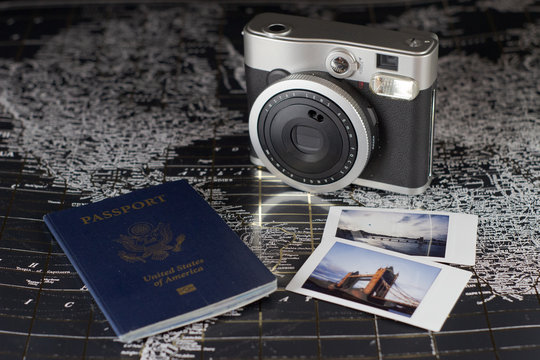 Getting ready to travel the world with passport and camera on a map
