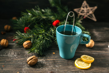 tea in blue cup on wooden table. christmas decoration.