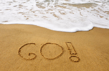 Go handwriting sign on the beach