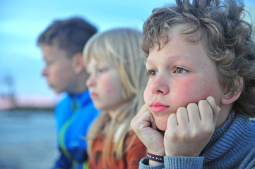 Portrait of three sad boys outdoors