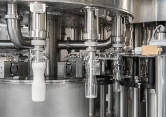 filling milk in to plastic bottles at the factory. equipment at the dairy plant