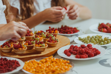 Tasty cupcakes with berries on gray table