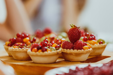Tasty cupcakes with berries on gray table