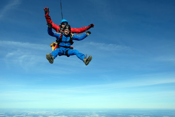 Tandem skydiving. Two happy men are in the sky.