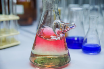 glass in green light, chemical science photo illustration, chemical experiment with liquid i glass,...