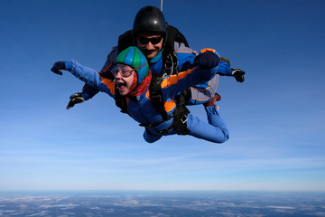 Skydiving. Tandem jump with happy girl.