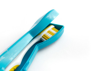 Toothbrush with a plastic case isolated on white background