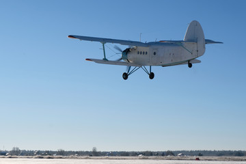 White biplane is taking off. © Sky Antonio