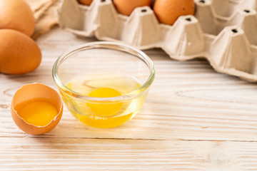 Brown eggs with one broken and egg yolk