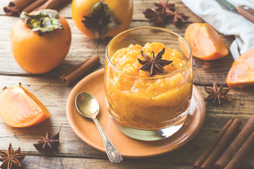 Persimmon fruit smoothie with cinnamon and anise stars, wooden table
