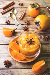Persimmon fruit smoothie with cinnamon and anise stars, wooden table