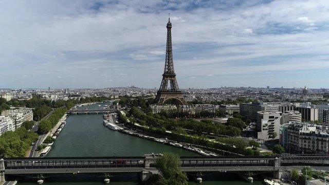 Aerial static footage of downtown Paris showing bridge over the Seine river and famous Eiffel tower on right side this city center is popular tourist destination in Europe 4k high resolution quality