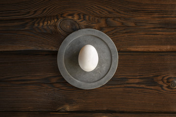 white egg on round concrete slab