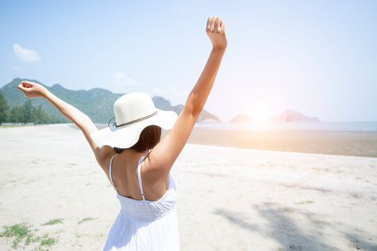 summer holidays, young woman in sun hat on beach over sea and blue sky background