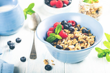 Homemade oatmeal granola or muesli with yogurt and fresh berries for healthy morning breakfast. Food background. Toned photo.
